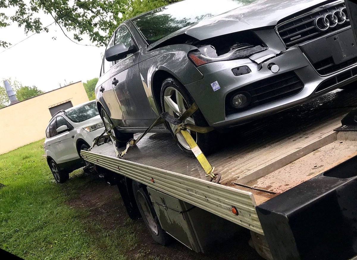 Car being winched onto the flatbed during a scrap car pickup in London, Ontario